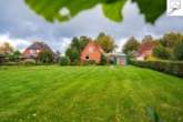 Garten - Rückansicht - Ein solides Einfamilienhaus in wunderschöner Kanallage in Oldeborg!